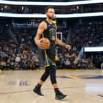 Stephen Curry holding basketball on professional court