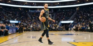 Stephen Curry holding basketball on professional court