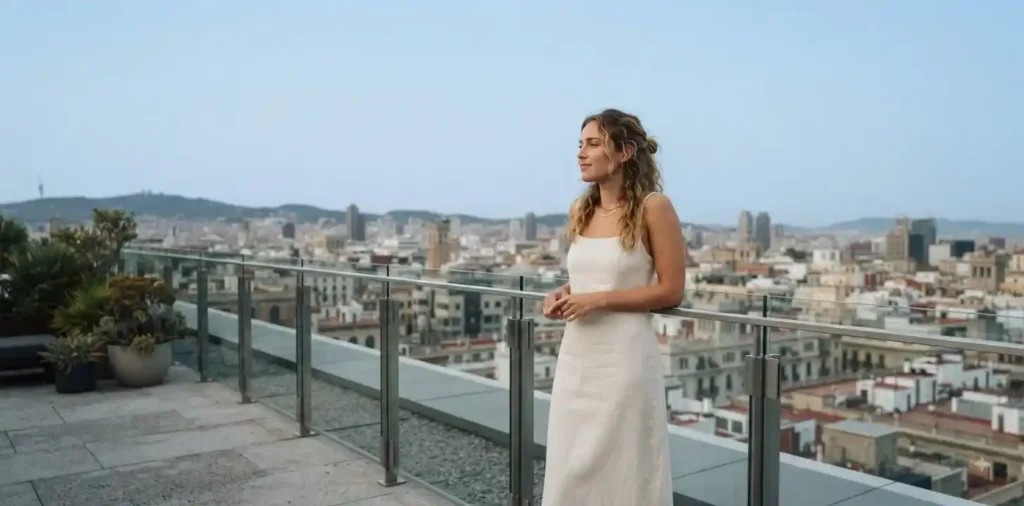 Woman standing on rooftop overlooking city skyline